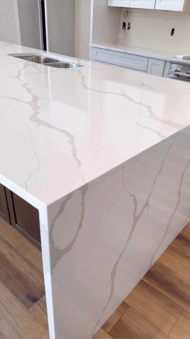 White Calacatta waterfall island with double undermount sink